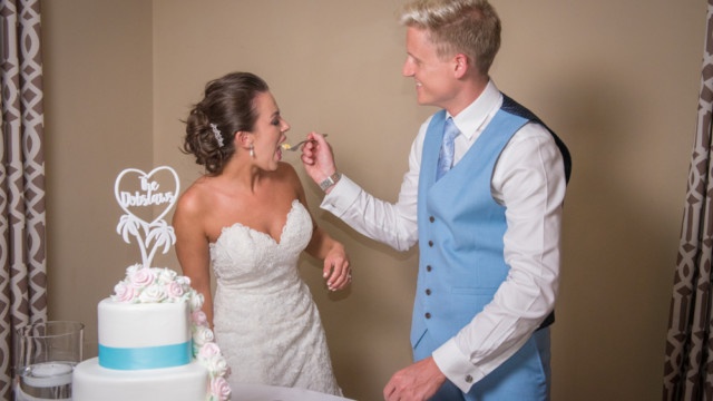 Wedding Cake Cutting Photo - Bride Eats the Cake